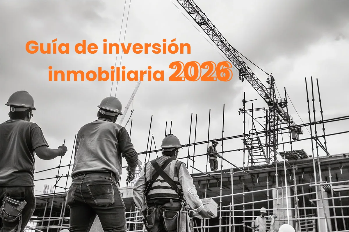 Trabajadores de la construccion con casco frente a una grua, bajo el titulo «Guia de inversion inmobiliaria 2026»