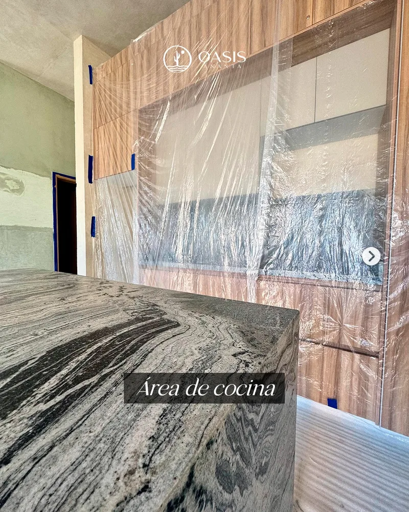 Area de cocina de un departamento en obra, con la piedra de la cubierta protegida con plastico